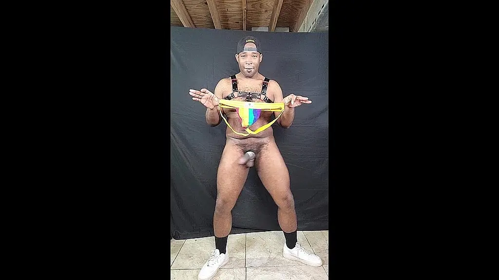 big dicked stud jerking huge cock in rainbow print jockstrap