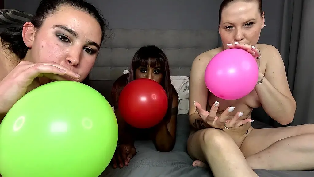 three interracial sluts squeaking balloons on each others nipples and pussies.