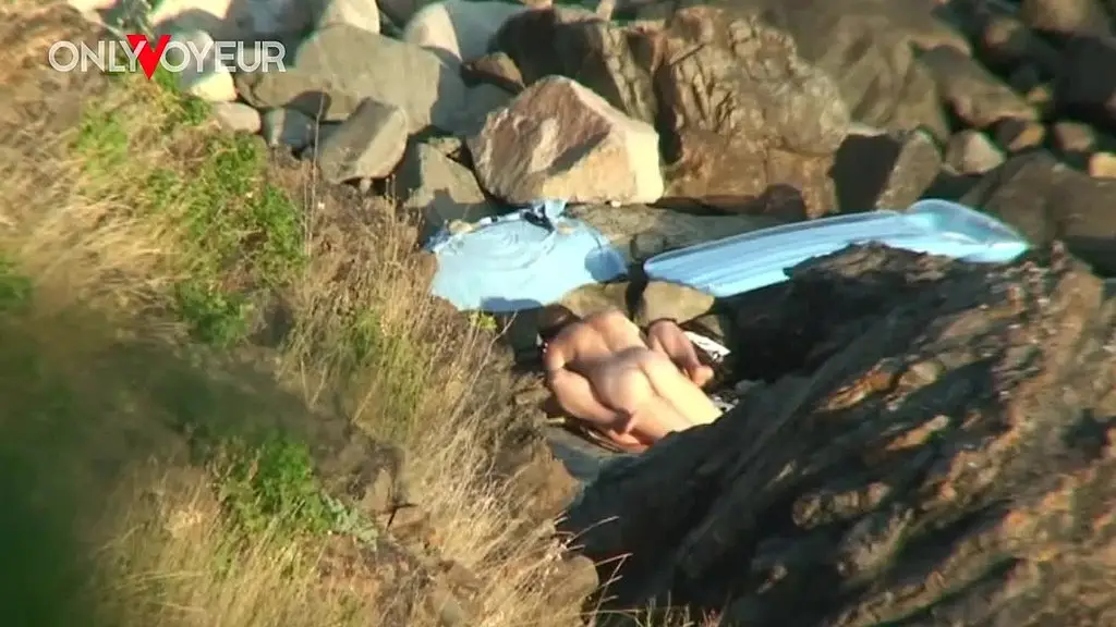 secret camera records horny young pair fucking between beach rocks