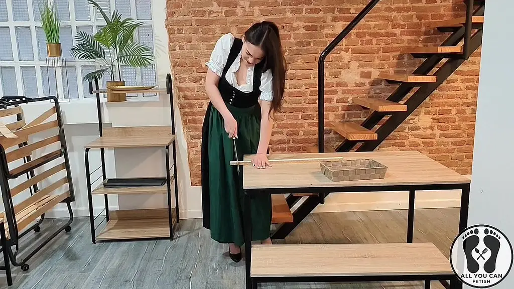 sensual latina carpenter cutting wood in a dirndl
