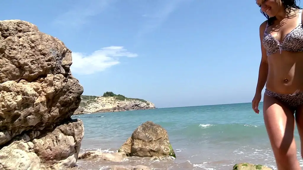 a brunette gets aroused on the beach and gets fucked in the pussy and ass during a double penetration.