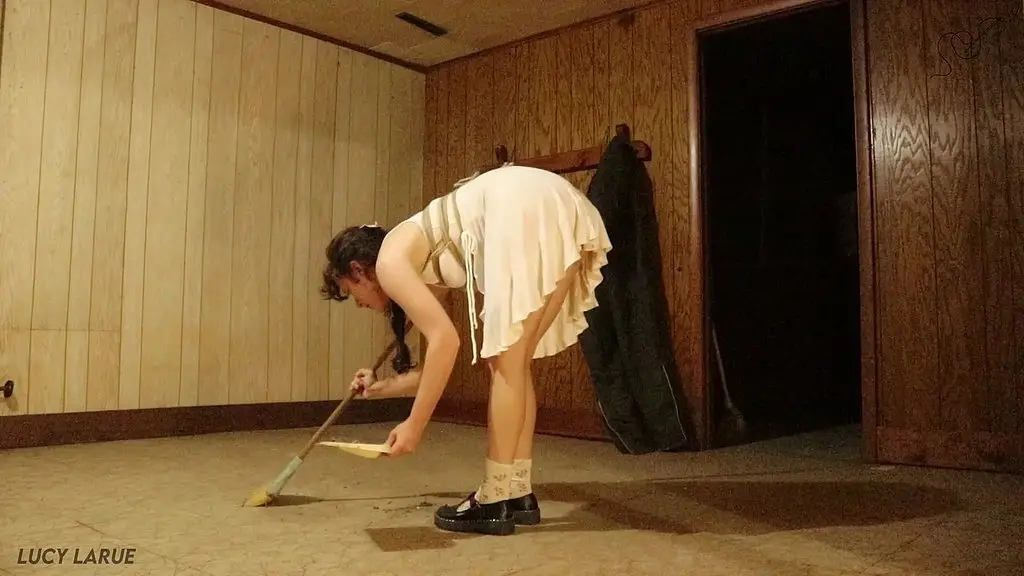 sub sweeps dirty basement in chest rope harness